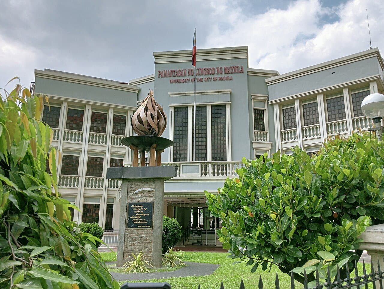The Pamantasan ng Lungsod ng Maynila (University of the City of Manila) building with the flame monument in front